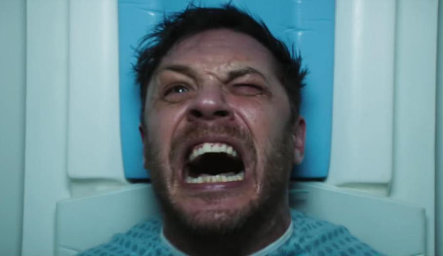 Tom Hardy / Eddie Brock miota się na badaniu rezonansem w filmie "Venom"